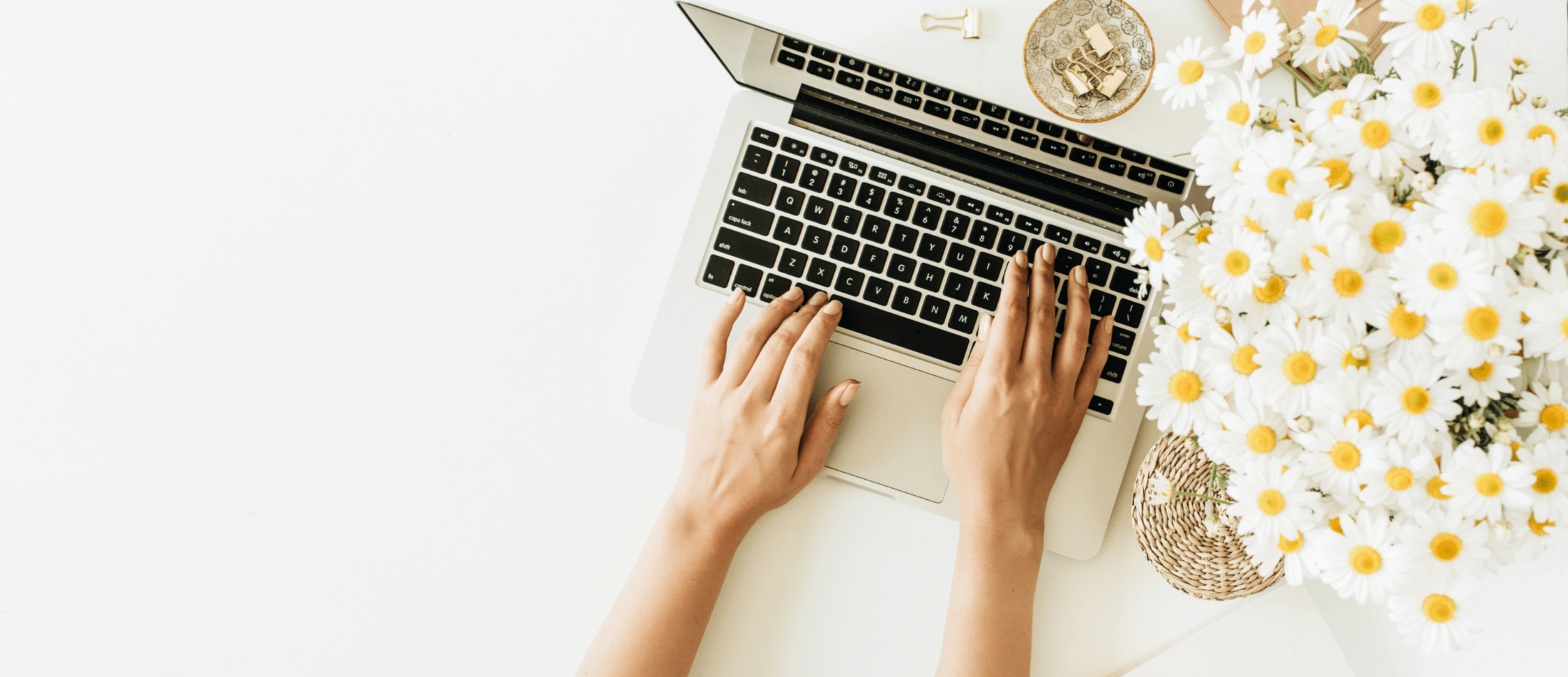 A therapist writing a mental health newsletter on a laptop